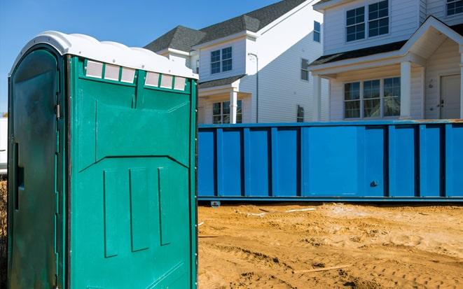 portable toilet and dumpster at a construction site in Fishers IN